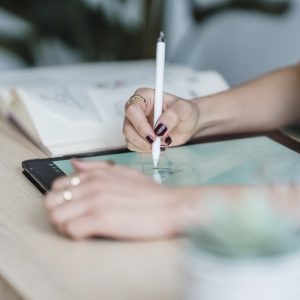 Anonymous female designer using tablet for drawing